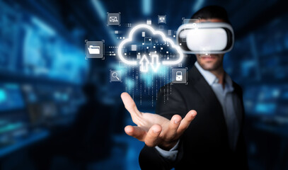 A professional businessman uses a virtual reality headset to interact with vivid cloud computing visuals, demonstrating innovative technology in a modern digital workspace. XDMCP