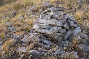stone deposits covered with yellow grass