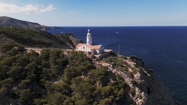 Aerial Drone Zoom Out From Capdepera Lighthouse Showing Rugged Coastline, Mallorca, Spain