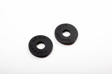 Round black rubber safety lock for guitar strap.