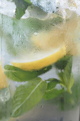 Refreshing lemon mint drink in a glass for hot summer days