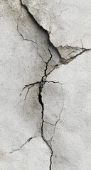 Obraz premium Extensive, deep fissures crisscross a light gray concrete surface, showcasing a distressed texture.