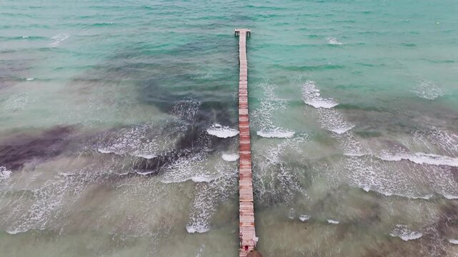 Aerial Drone Overhead View Of Moll De Fusta Pier On A Mallorcan Beach With Turquoise Mediterranean Sea, Mallorca, Spain.