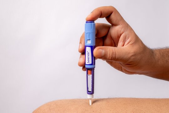 Close-up of a Saxenda injection pen displaying dosage in milligrams on a white background.