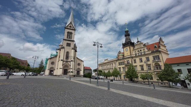 square in Kladno city, Czechia, Europe with town hall, church, blue sky with clouds