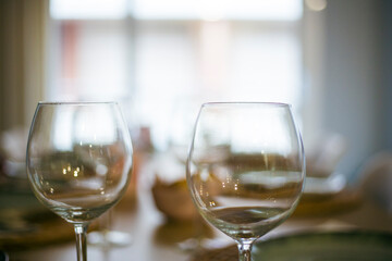 Empty wineglasses on a beautiful cutlery interior restaurant nobody on the frame close up still
