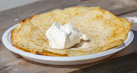 A plate of pancakes with whipped cream on top