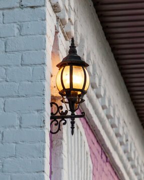 Fototapeta A lamp is hanging from a white wall