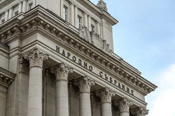The National Assembly building features neoclassical architecture with Corinthian columns and ornate decorative details, representing an important political and historic landmark.