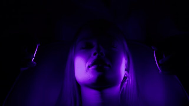 A young woman in close-up undergoing cryotherapy in a modern cosmetic center. Concept effective skin rejuvenation and restoration.