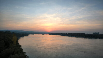 Fototapeta premium colorful sunset sunrise sky over the Danube river and city of Novi Sad