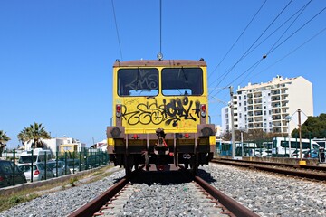 Graffiti covered train on railway tracks in Faro. Portugal