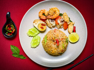 Thai seafood fried rice with shrimp, squid, and mussels stir-fried with jasmine rice, eggs, and aromatic seasonings for a savory flavor.