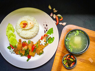 Spicy Thai stir-fry with crispy pork belly and fragrant holy basil, served with rice for a flavorful street food favorite.