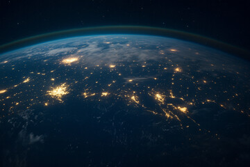 Obraz premium Earth at night from space showing city lights and atmosphere