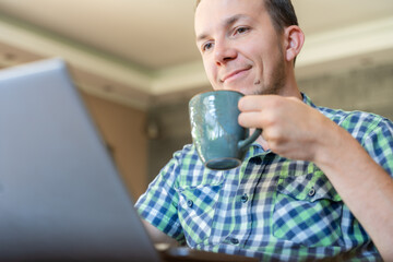 Man With Laptop And Coffee During Remote Work At Home, Freelancer Online In Casual Morning Routine,...