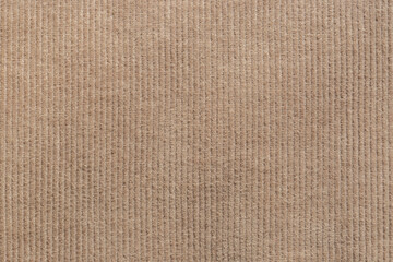 Close-up of brown corduroy trousers pants fabric background backdrop. Traditional fashion garment fabric concept.