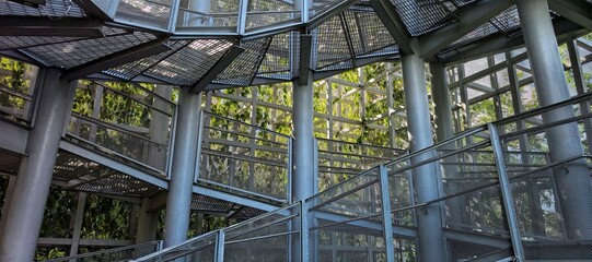 A captivating view of a metallic staircase surrounded by lush greenery.