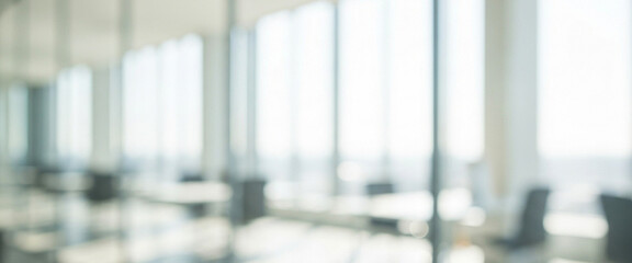 Blurred office space with large windows and chairs in a bright setting, featuring natural daylight, open arrangement, and a modern minimalistic working mood.
