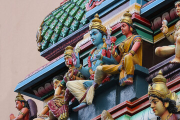   Sculpture of Hindu God Vishnu with Goddess Lakshmi on ornate temple shikhara dome, sacred symbol...