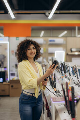Smiling Woman Shopping for Hair Tools at an Electronics Store