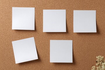 Empty white and brown sticky notes pinned on a corkboard for reminders, planning, organization, or creative workspace concepts.