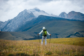 Woman backpacking on high altitude mountain top