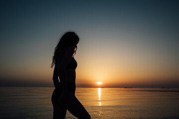Sunset, sexy woman silhouette sea