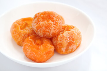 Traditional Korean Dried Persimmons on White Plate