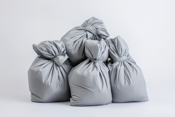 A collection of Stacked Gray Garbage Bags arranged neatly on a White Background surface