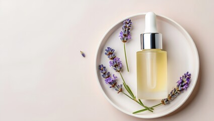 Glass dropper bottle of essential oil with lavender sprigs on a white oval dish
