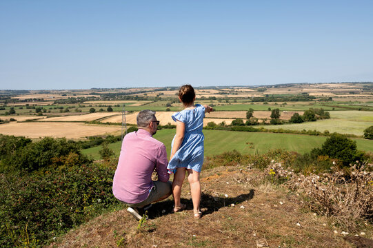 Father and daughter enjoying countryside view together.