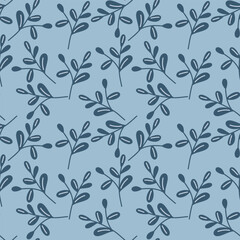 Monochrome seamless pattern with dark blue branches and leaves on soft blue background for elegant winter textile and wrapping.