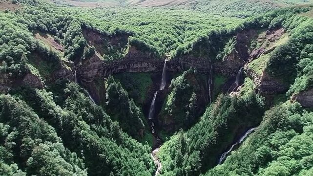 Aerial View of Lush Green Forest with Multiple Waterfalls