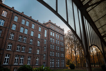 Historic brick building facade viewed through traditional archway columns
