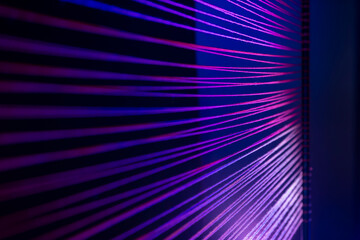 Abstract purple string artwork creating geometric parallel line patterns