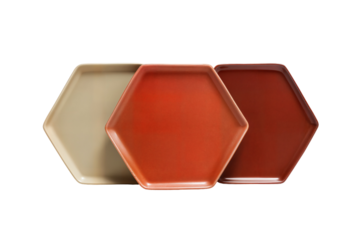 Three hexagon ceramic plates in neutral orange and terracotta tones for modern table setting decor on transparent background