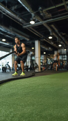 Fototapeta premium Gym Training Product Mockup — Athlete with Battle Ropes, Green Turf Copy Space for Fitness & Supplements