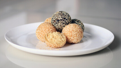 Onde-onde or sesame balls on a white plate. A famous snack cake in Indonesia.