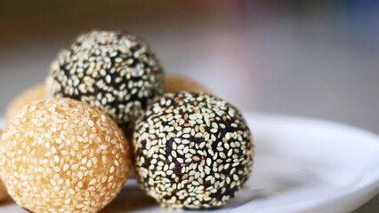 Onde-onde or sesame balls on a white plate. A famous snack cake in Indonesia.