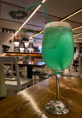 Non-alcoholic drink in a glass cup and straw