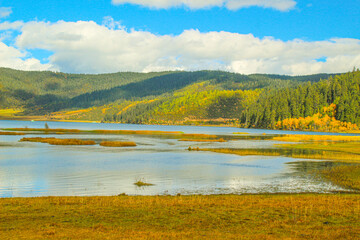 Colorful hills and blue lakes create a serene panorama
Pudacuo National Park, Yunnan, China, Shangri-La