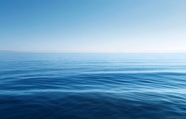 Obraz premium Calm blue ocean stretching to the horizon under a clear sky, capturing the vastness and tranquility of the sea in a serene, minimalist composition