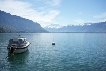 boat on the lake with snowy mountains