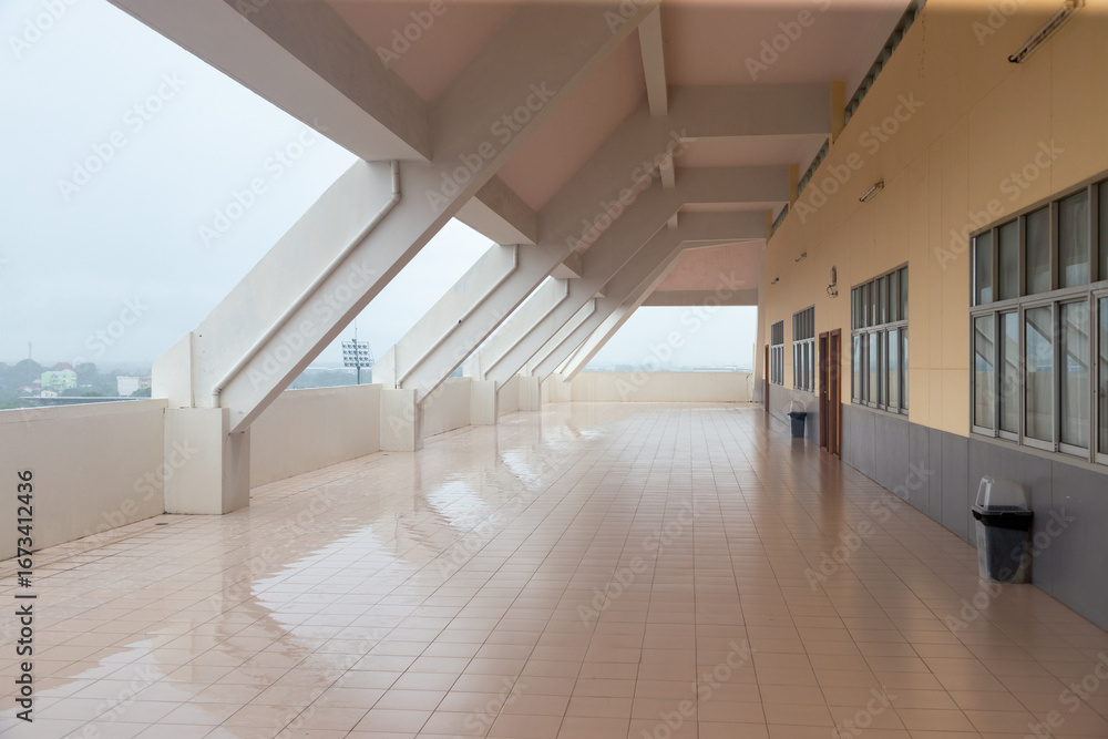 Aufkleber an empty and elegant corridor in a modern building with tiled floors and a homely design.