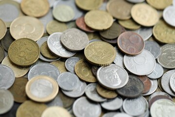 Big pile of different coins from various currencies and different countries around the world. Currency exchange