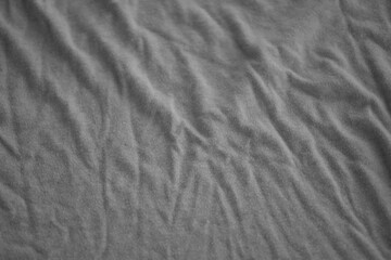 Obraz premium Texture of Dark grey crumpled textile cloth part with small folds