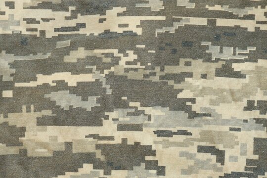 Texture of Dark green pixel camouflage military uniform textile cloth with folds