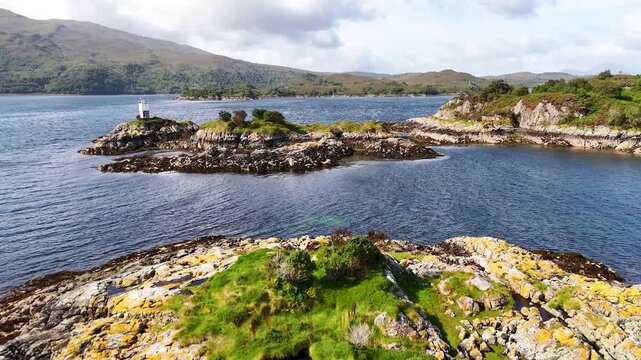 Aerial Approach to Small Rocky Isle with Lighthouse, Scotland
