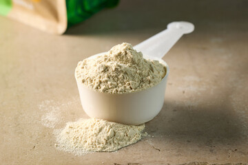 protein powder in scoop. dry mixture for preparation of sporting or dietary drink.
